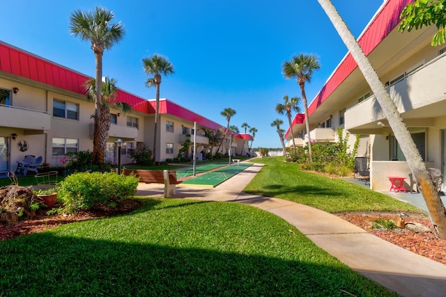 view of property's community with a lawn