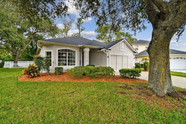 ranch-style house featuring a front yard and a garage