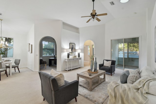 living room with ceiling fan, light carpet, and vaulted ceiling