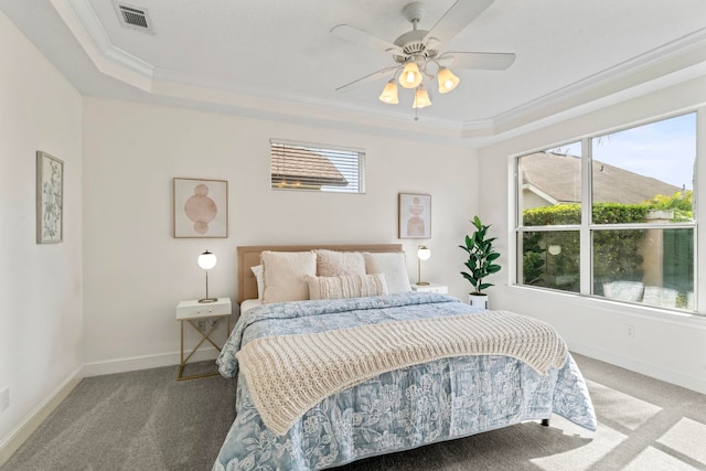 bedroom featuring crown molding, ceiling fan, a tray ceiling, and carpet floors