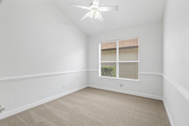 carpeted spare room with ceiling fan and vaulted ceiling