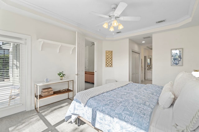 bedroom with crown molding, light colored carpet, a raised ceiling, and ceiling fan