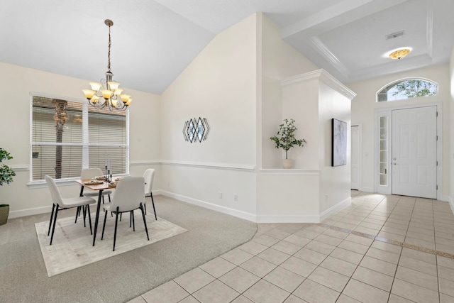 tiled dining room featuring vaulted ceiling and an inviting chandelier