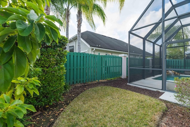 view of yard with a fenced in pool and a lanai