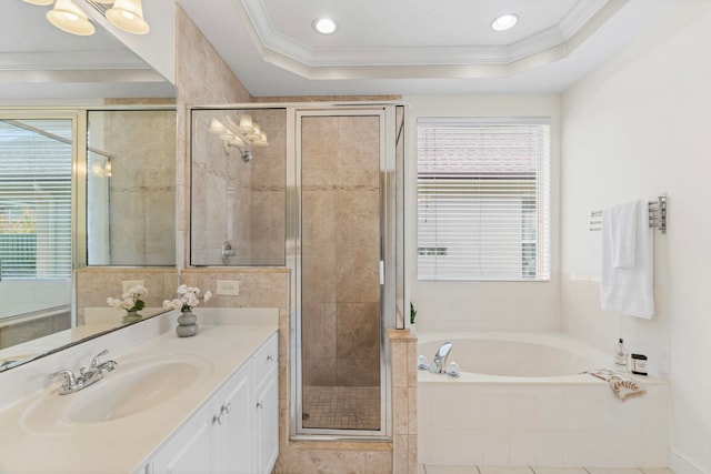 bathroom with crown molding, plenty of natural light, and a raised ceiling