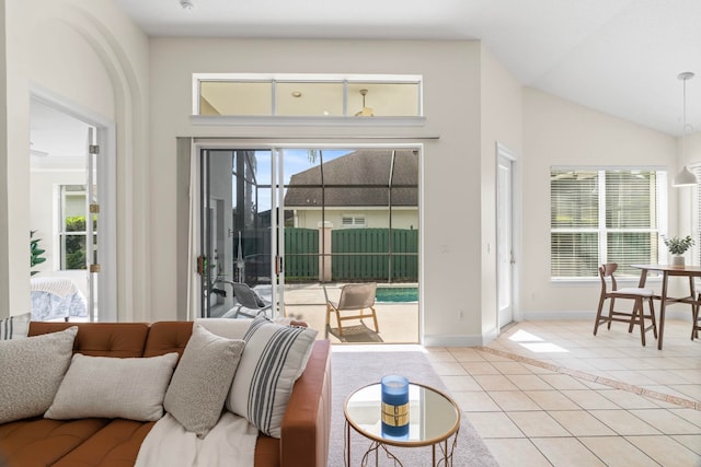 tiled living room with vaulted ceiling and a wealth of natural light