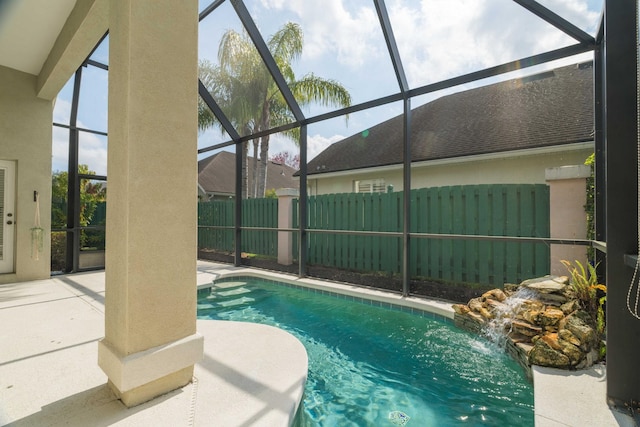 view of swimming pool featuring a lanai and a patio