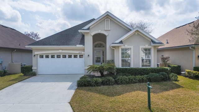 view of front of house with a garage and a front yard