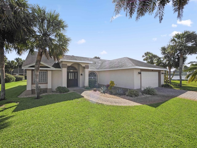 single story home featuring a front lawn and a garage