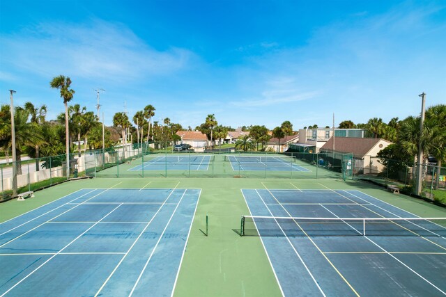 view of tennis court with basketball hoop