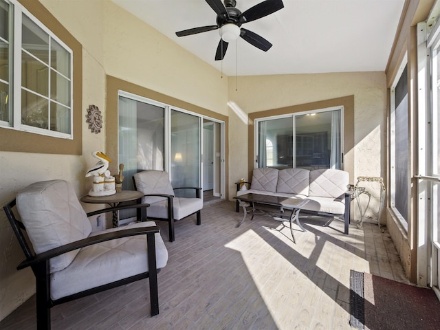 sunroom / solarium with ceiling fan and vaulted ceiling