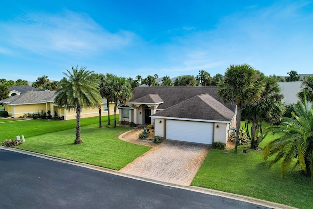 ranch-style house featuring a front yard and a garage