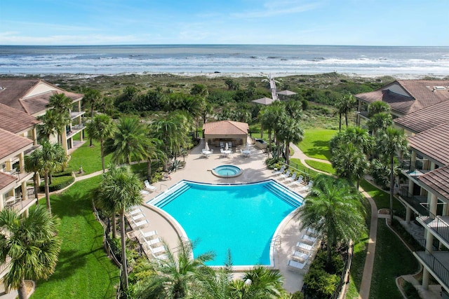 view of pool with a water view and a patio area