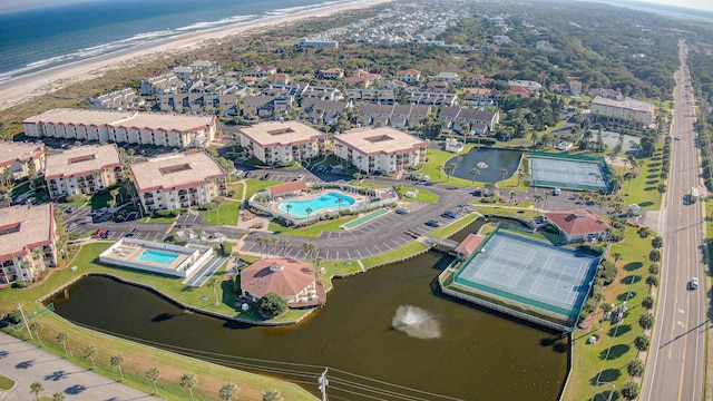 drone / aerial view with a water view and a beach view