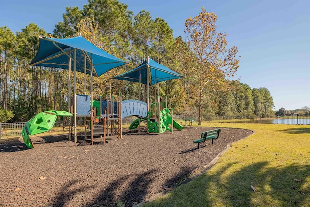 view of play area featuring a yard and a water view