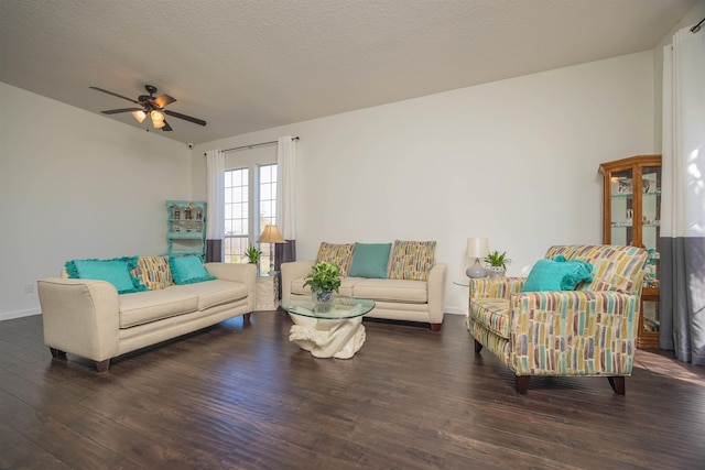 living room featuring a textured ceiling, dark hardwood / wood-style floors, and ceiling fan