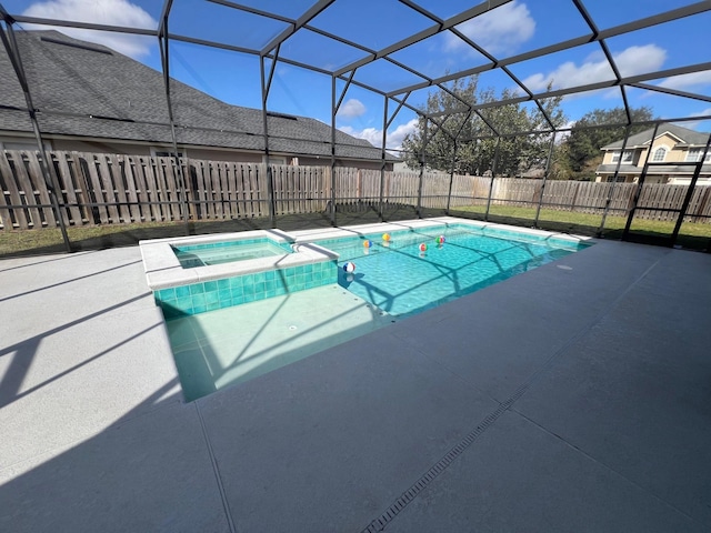 view of pool featuring a lanai, a patio area, and an in ground hot tub