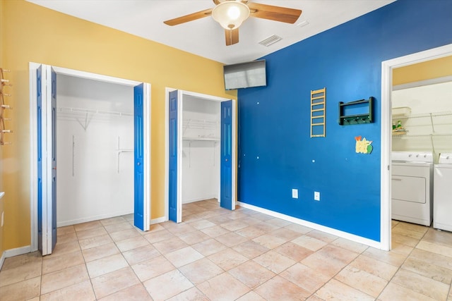 unfurnished bedroom featuring visible vents, two closets, independent washer and dryer, baseboards, and ceiling fan