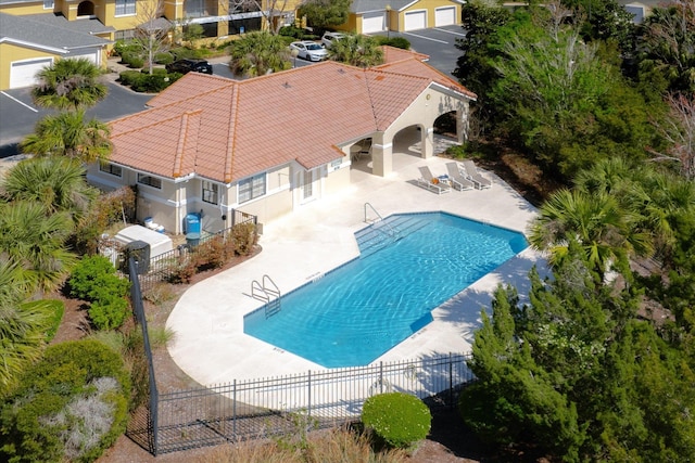 pool featuring a patio area and fence