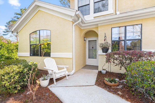 property entrance with stucco siding