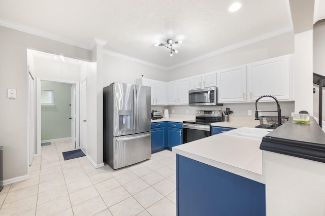 kitchen with blue cabinetry, appliances with stainless steel finishes, and ornamental molding