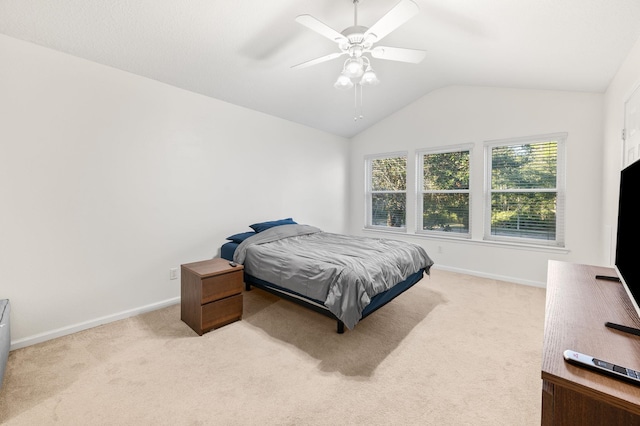 bedroom featuring light carpet, lofted ceiling, and baseboards