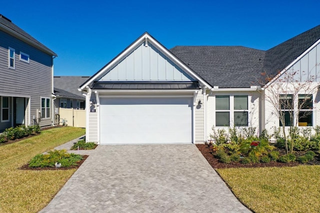 view of front of property featuring a front yard and a garage