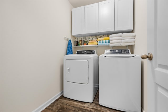 laundry area with baseboards, dark wood-style flooring, washer and dryer, and cabinet space