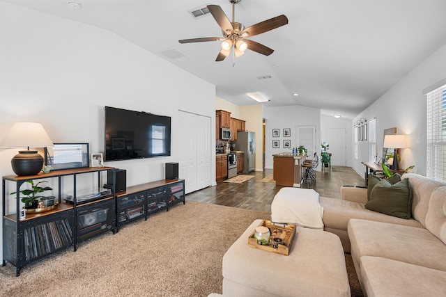 living area featuring vaulted ceiling, visible vents, ceiling fan, and dark wood-style floors