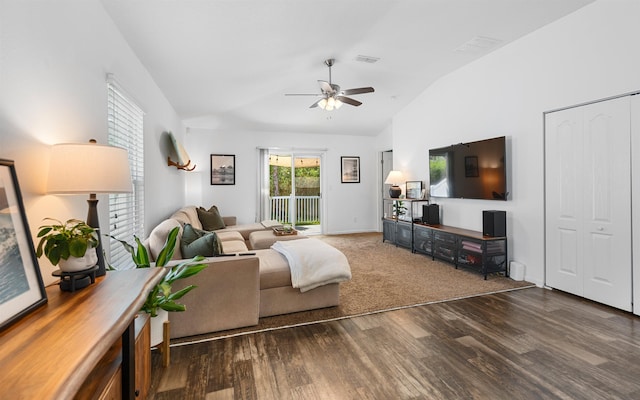 living room featuring wood finished floors, visible vents, baseboards, ceiling fan, and vaulted ceiling