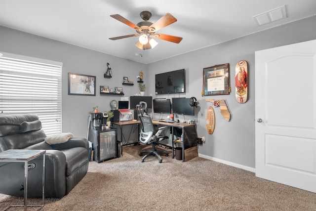 home office featuring carpet, visible vents, baseboards, and ceiling fan