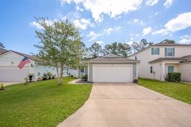 view of front of home with an attached garage, a front yard, and driveway