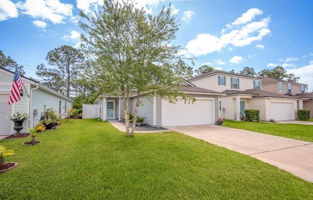 traditional home featuring concrete driveway, a front yard, and an attached garage