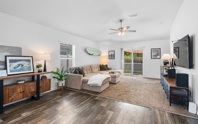 living room featuring visible vents, wood finished floors, baseboards, and ceiling fan