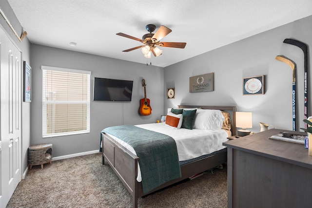 bedroom with baseboards, multiple windows, ceiling fan, and carpet floors