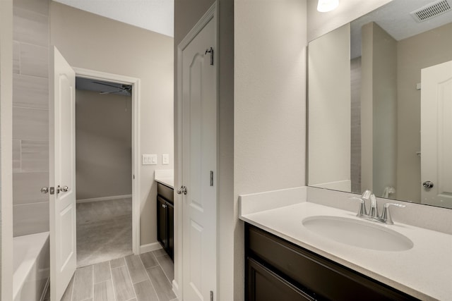 bathroom featuring vanity and a washtub