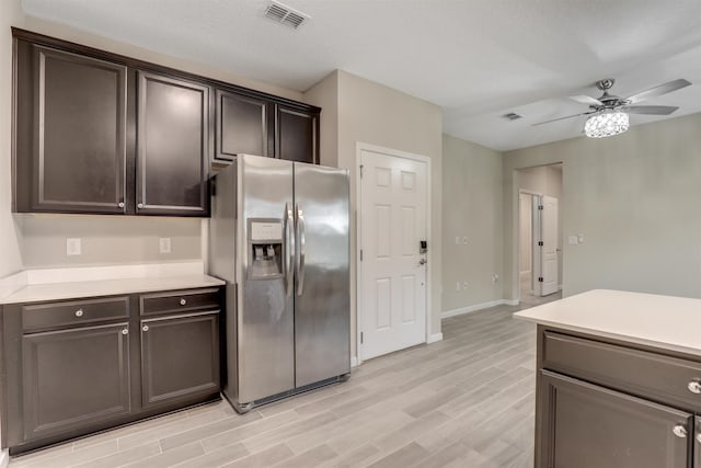 kitchen featuring stainless steel fridge with ice dispenser, dark brown cabinets, light hardwood / wood-style flooring, and ceiling fan