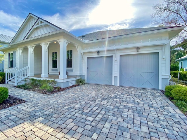 view of front facade with covered porch and a garage