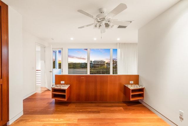 empty room with ceiling fan and light wood-type flooring