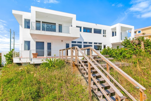 rear view of house featuring a deck