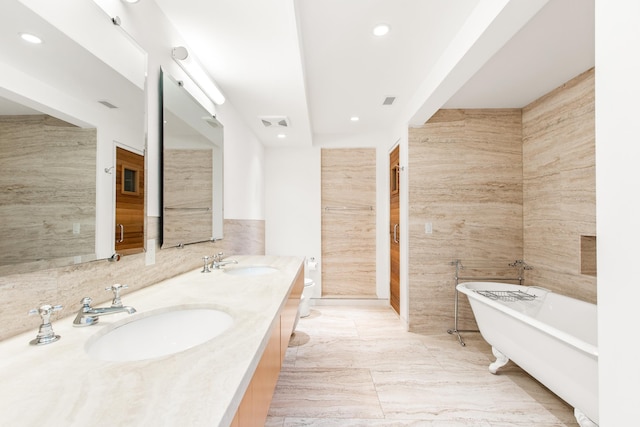 bathroom with a bathtub, toilet, tile walls, and vanity