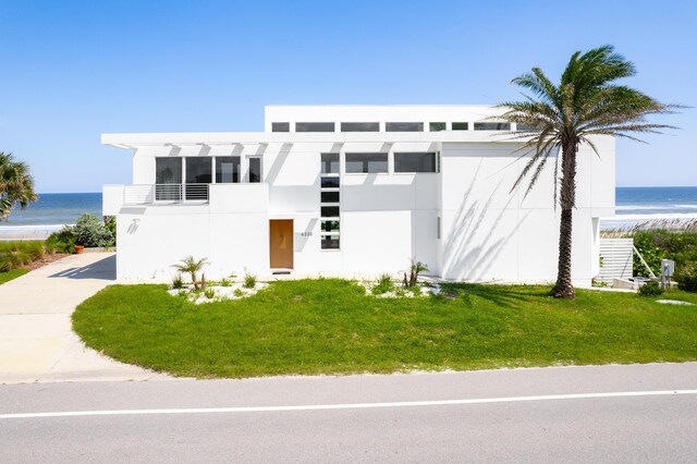 view of front of property with a water view and a front yard