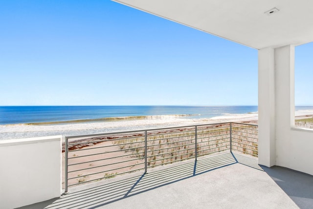 balcony with a view of the beach and a water view