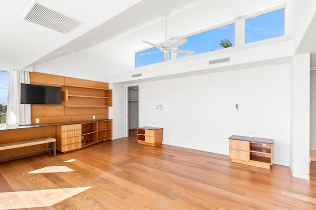 unfurnished living room featuring light hardwood / wood-style flooring, high vaulted ceiling, and ceiling fan