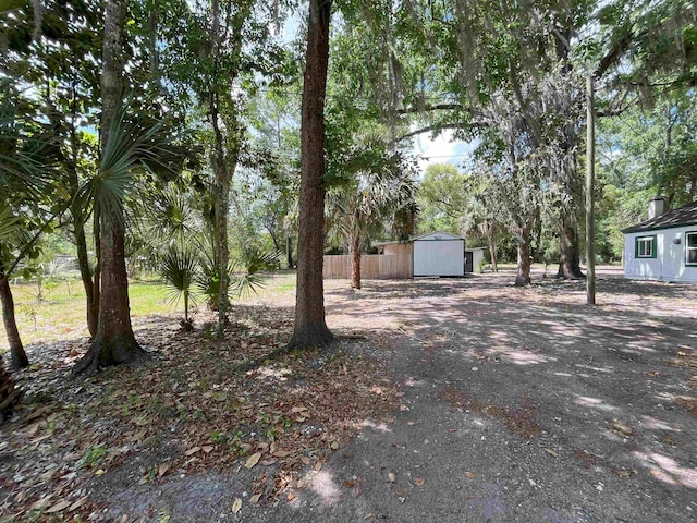 221 Old Peniel Rd, Palatka, FL 32177 - view of yard featuring a shed, an outbuilding, and fence