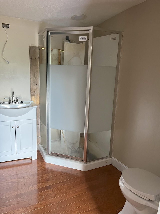 221 Old Peniel Rd, Palatka, FL 32177 - full bathroom featuring vanity, wood finished floors, toilet, baseboards, and a shower stall