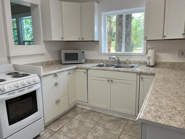 221 Old Peniel Rd, Palatka, FL 32177 - kitchen featuring a sink, light countertops, white appliances, and a healthy amount of sunlight