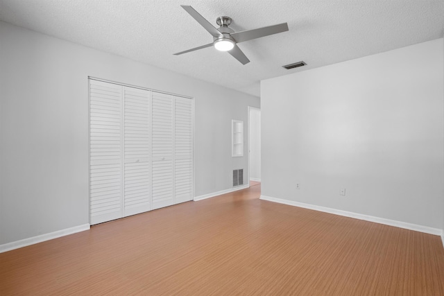 422 Nervia Ct, Saint Augustine, FL 32086 - unfurnished bedroom featuring a closet, visible vents, a textured ceiling, and wood finished floors