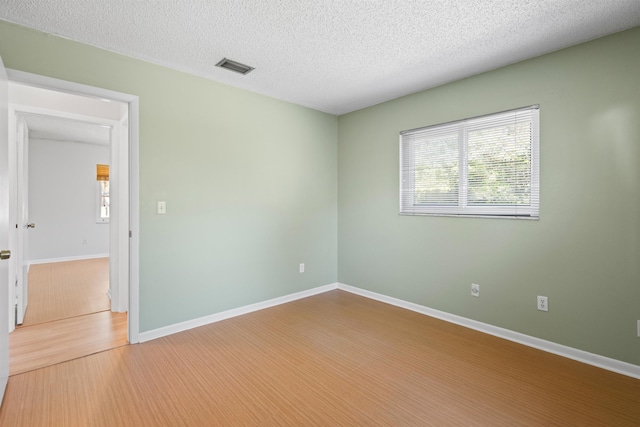 422 Nervia Ct, Saint Augustine, FL 32086 - spare room with visible vents, a textured ceiling, baseboards, and wood finished floors