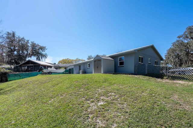 422 Nervia Ct, Saint Augustine, FL 32086 - rear view of house with an outbuilding, a yard, and fence